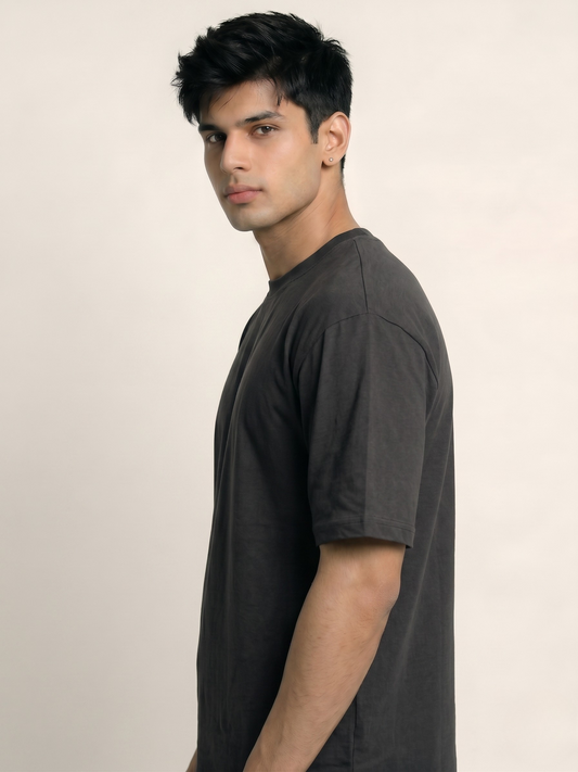 Man wearing a black t-shirt against a beige background