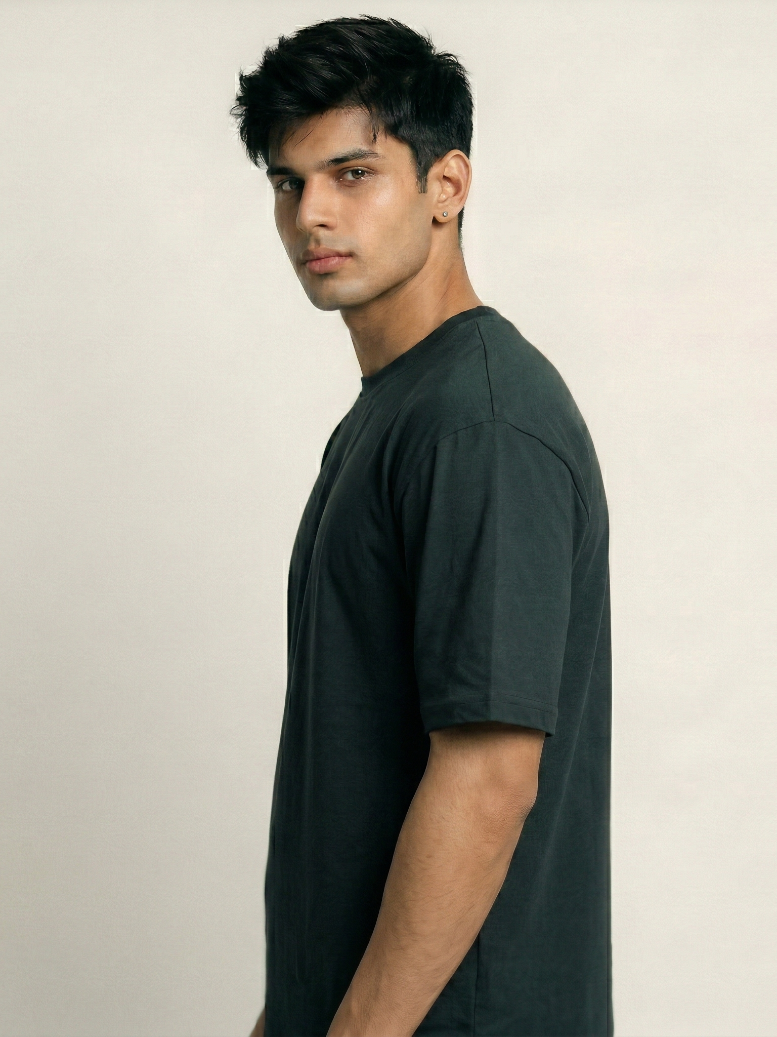 Man wearing a black t-shirt against a plain background
