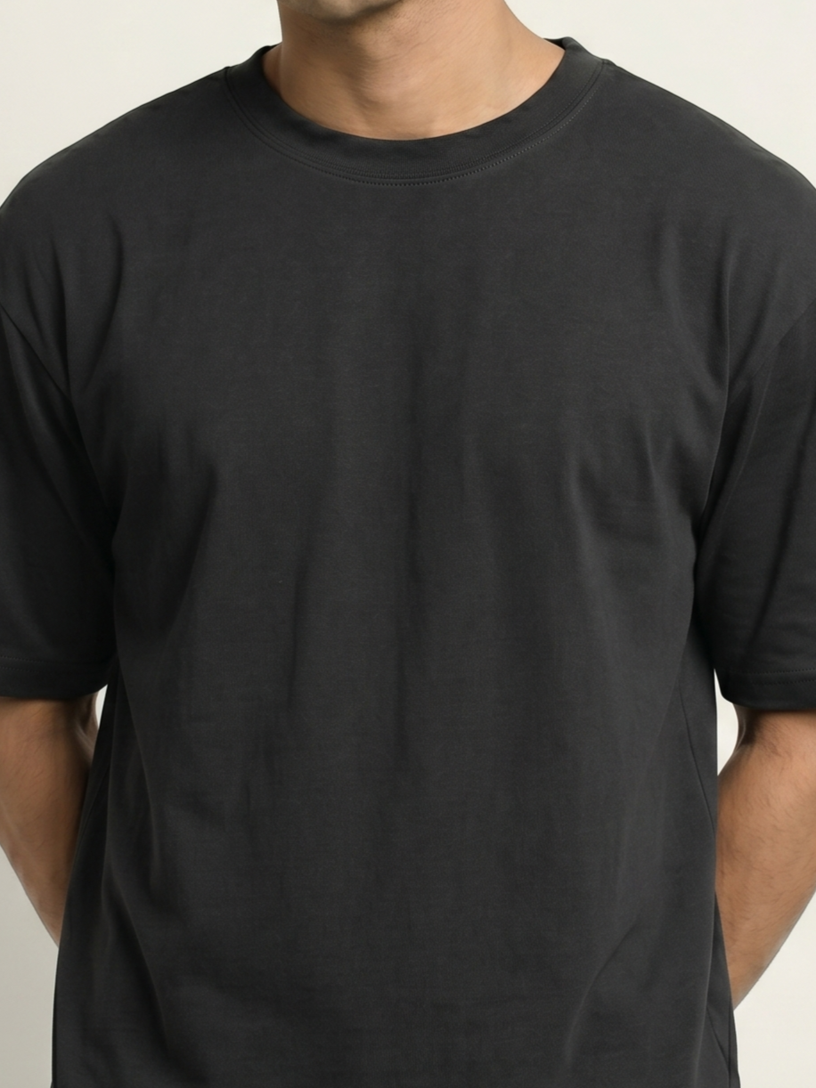 Black t-shirt worn by a person on a neutral background