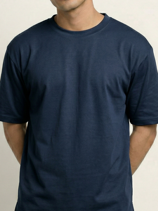 Navy blue t-shirt worn by a person on a beige background